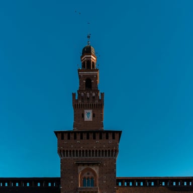 Tall granite tower rising against a clear blue sky