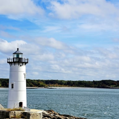 New England lighthouse standing on the water