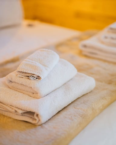 Fresh towels and linens in a vacation home bedroom
